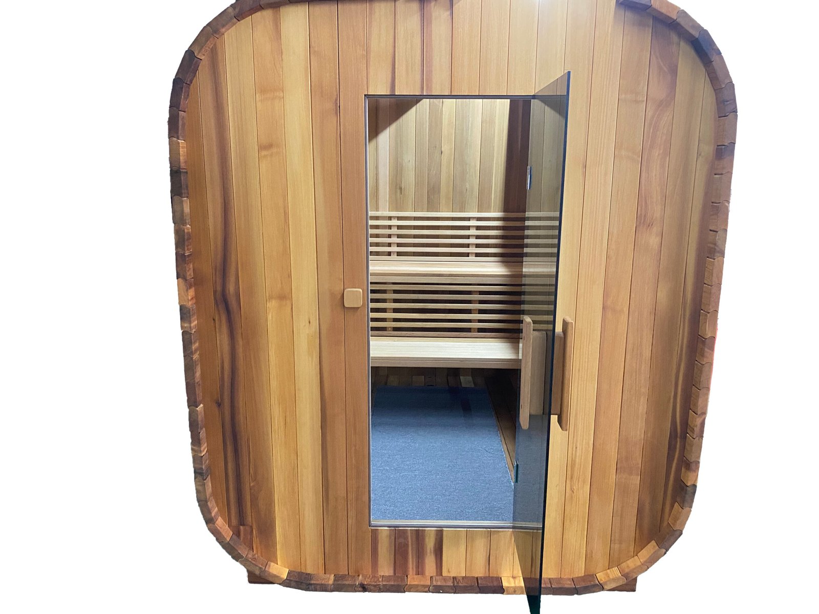 Front of square red cedar sauna with gray glass door, rectangular wood handle, and visible rectangular bench inside