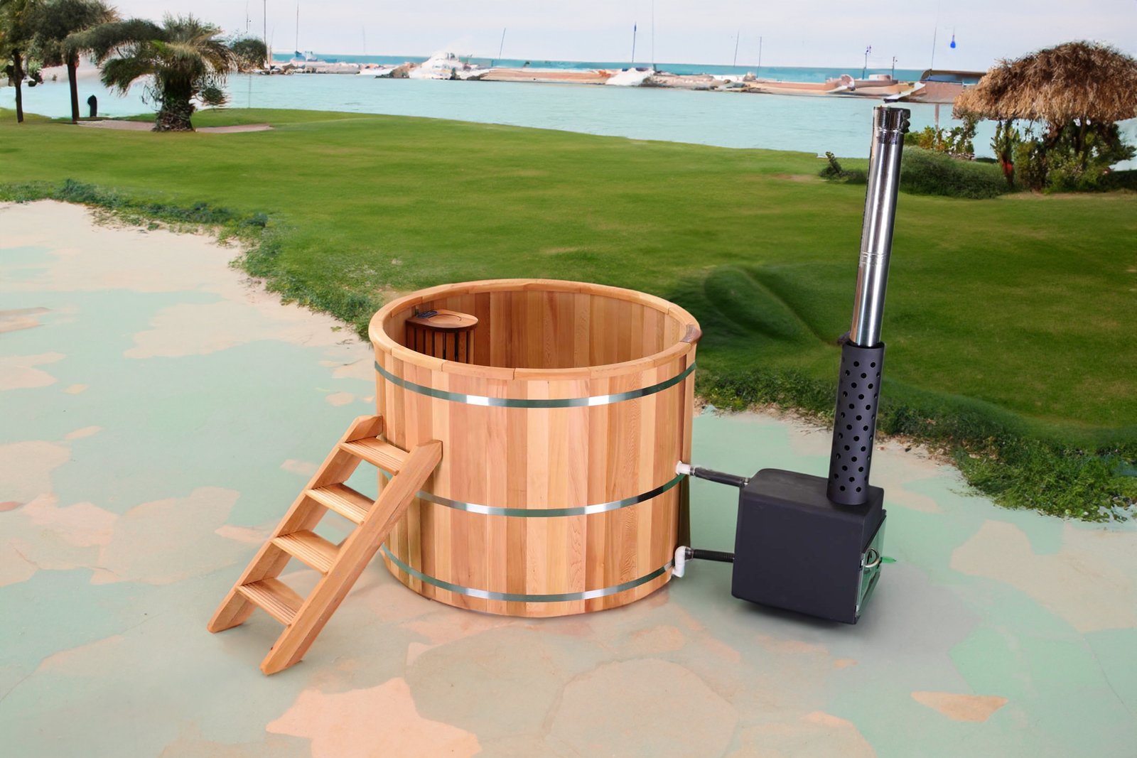 Wood-fired hot tub on grass by the sea, with black-coated 304 stainless steel stove and ladder